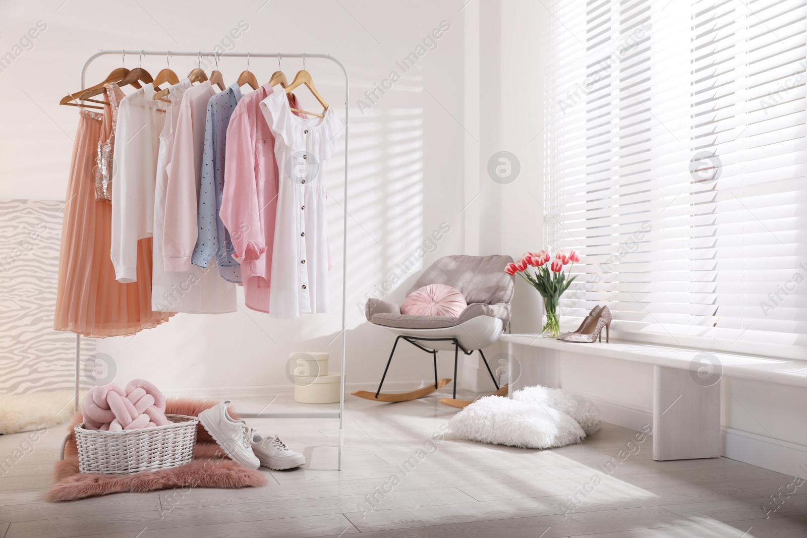 Photo of Rack with stylish women's clothes indoors. Interior design