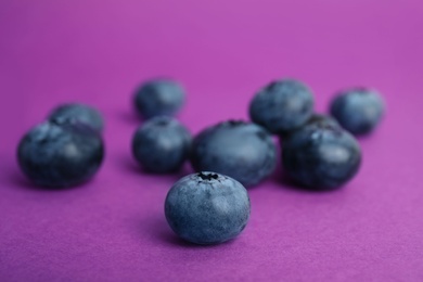 Photo of Tasty ripe blueberry on color background, closeup