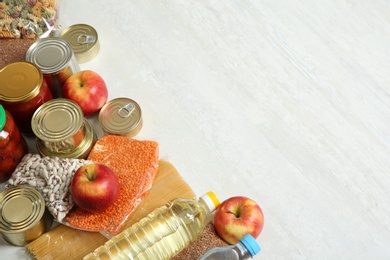 Photo of Many different products and space for text on white wooden background. Food donation