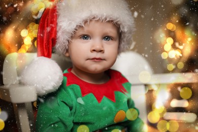 Image of Baby in cute elf costume sitting on chair at home. Christmas celebration 