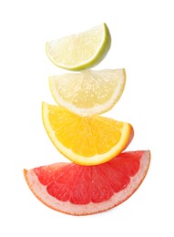 Cut fresh citrus fruits isolated on white