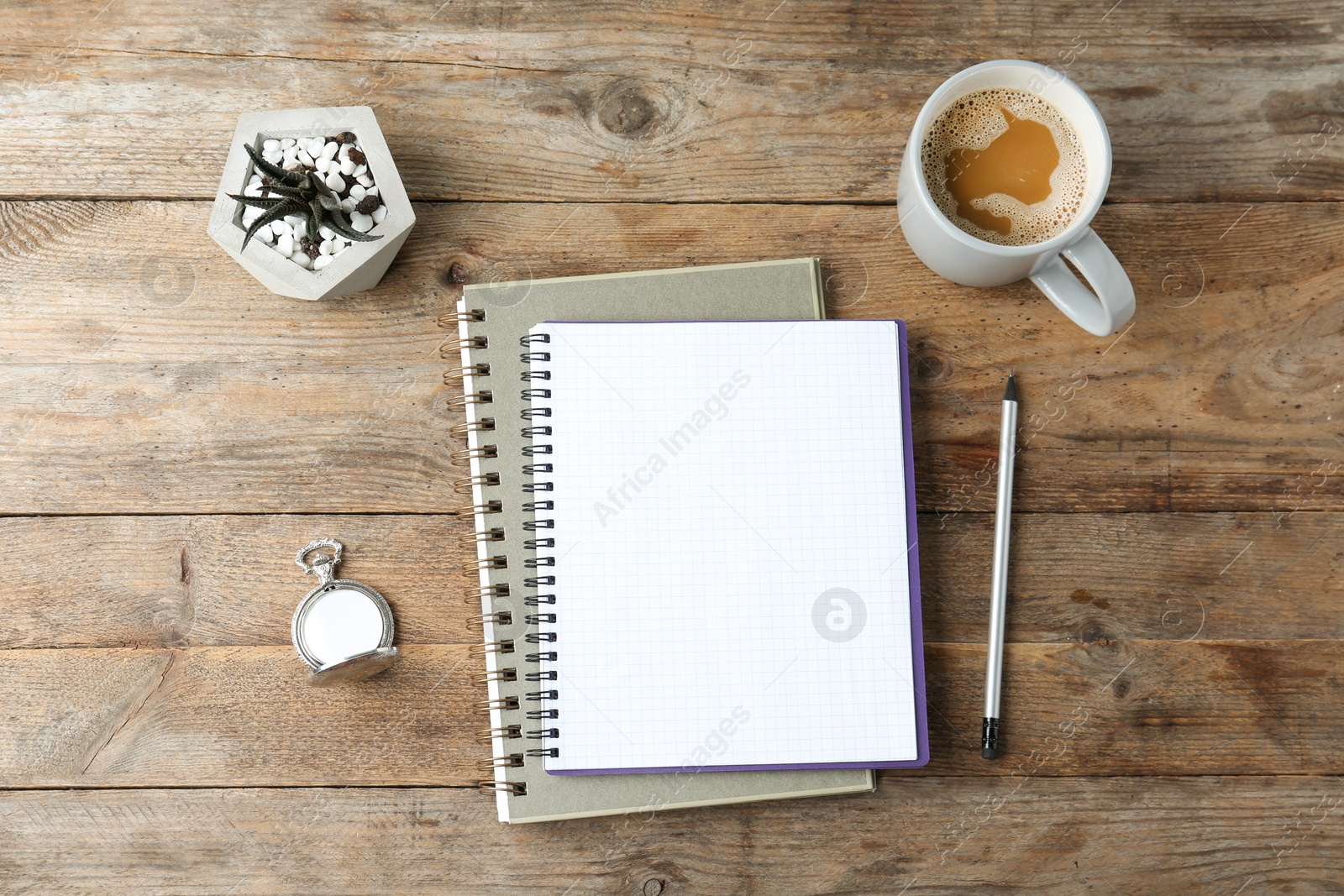 Photo of Flat lay composition with office stationery and cup of coffee on wooden table. Space for design