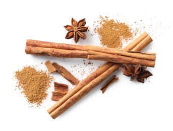 Photo of Dry aromatic cinnamon sticks, powder and anise stars isolated on white, top view