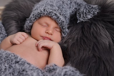 Photo of Adorable newborn baby lying on faux fur