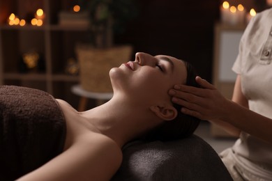 Photo of Spa therapy. Beautiful young woman lying on table during massage in salon