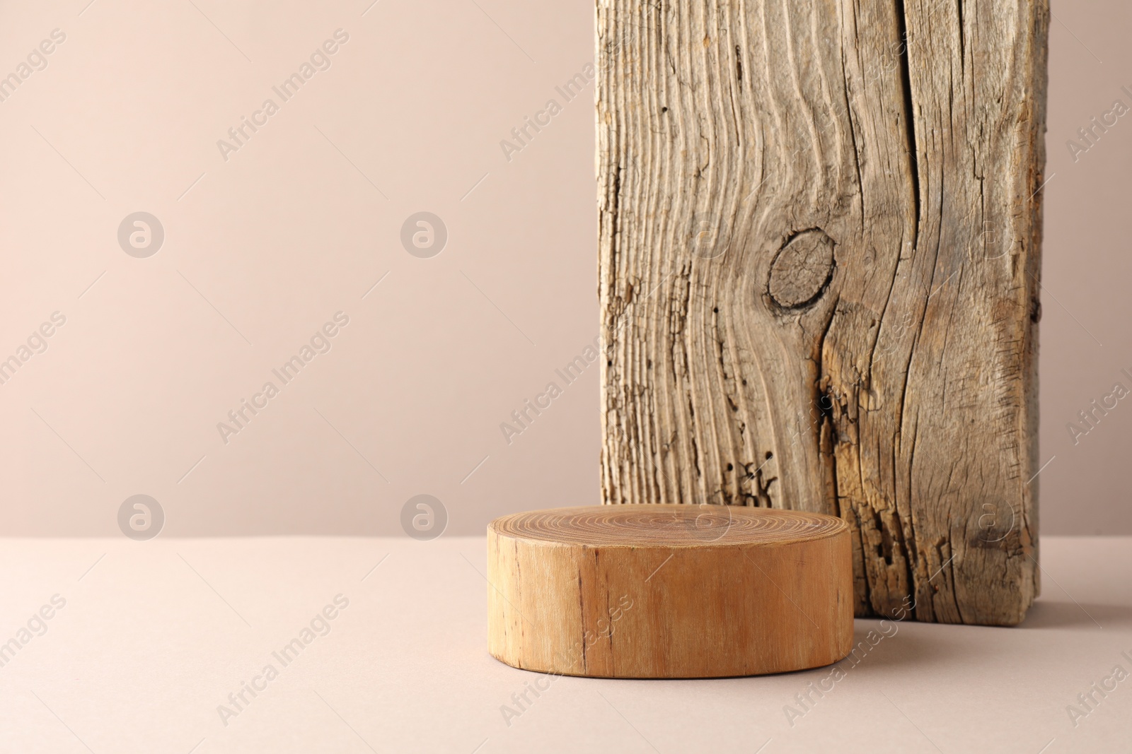 Photo of Presentation for product. Wooden podium on beige background. Space for text