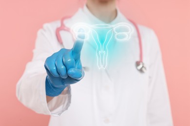 Doctor and illustration of female reproductive system on pink background, closeup