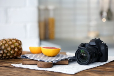 Photo of Professional camera and fruits on table. Food blog