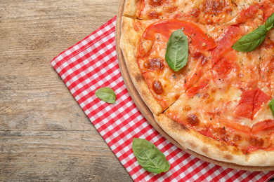 Delicious pizza Margherita on wooden table, top view