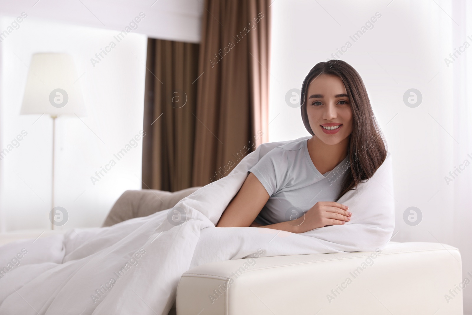 Photo of Woman covered in blanket resting on sofa, space for text