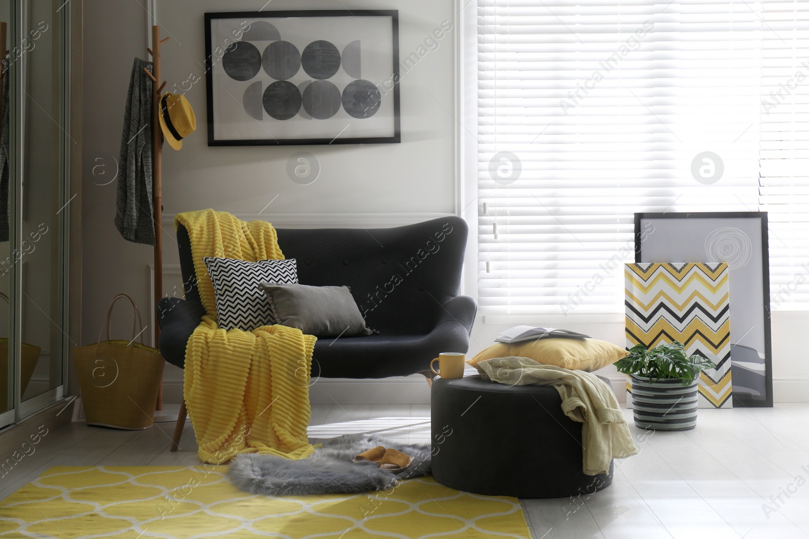 Photo of Comfortable sofa with pillows and plaid in living room. Interior design