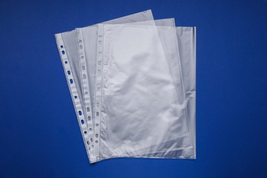 Punched pockets on blue background, flat lay