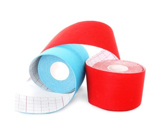 Photo of Many bright kinesio tape in rolls on white background