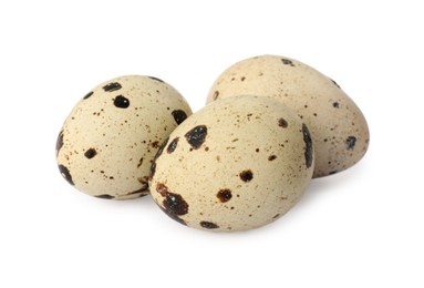 Photo of Beautiful speckled quail eggs on white background