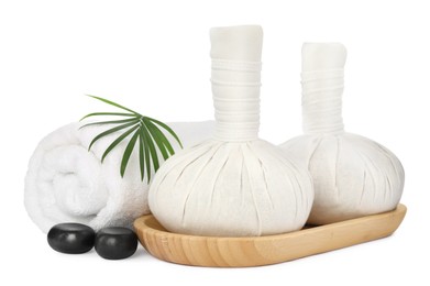 Herbal massage bags, spa stones, towel and green leaf on white background