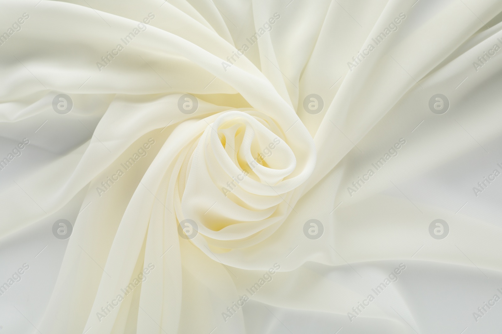 Photo of Beautiful white tulle fabric as background, top view