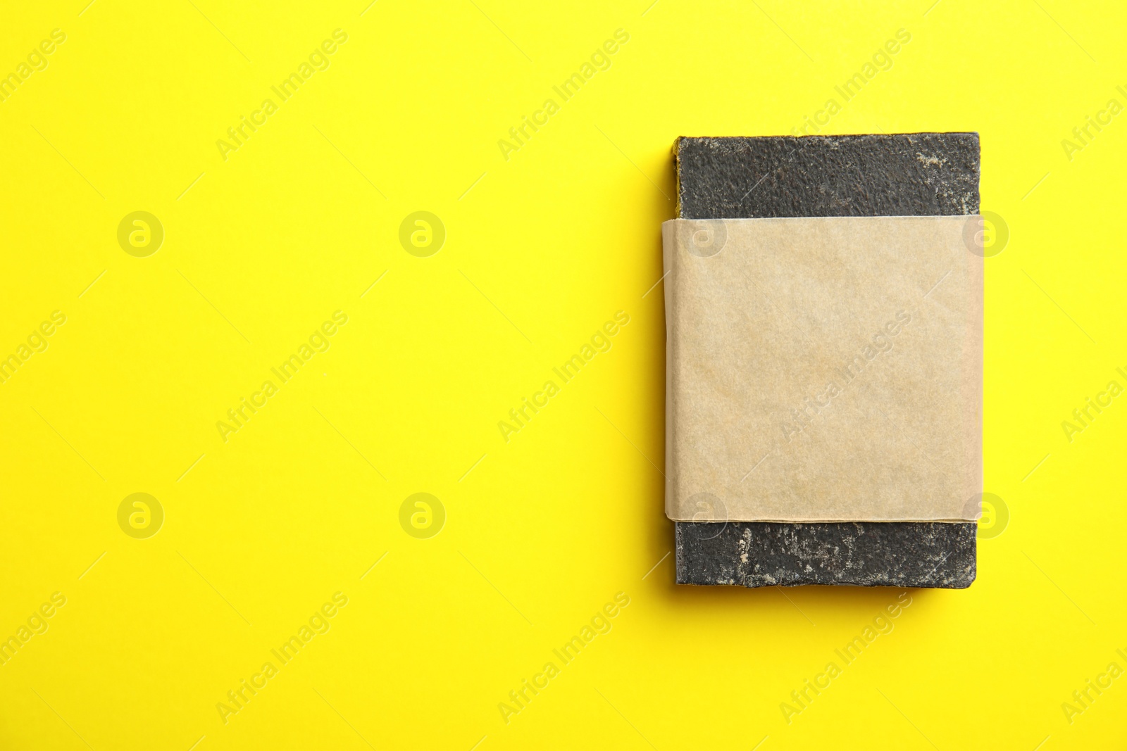 Photo of Hand made soap bar in package on color background, top view. Space for text