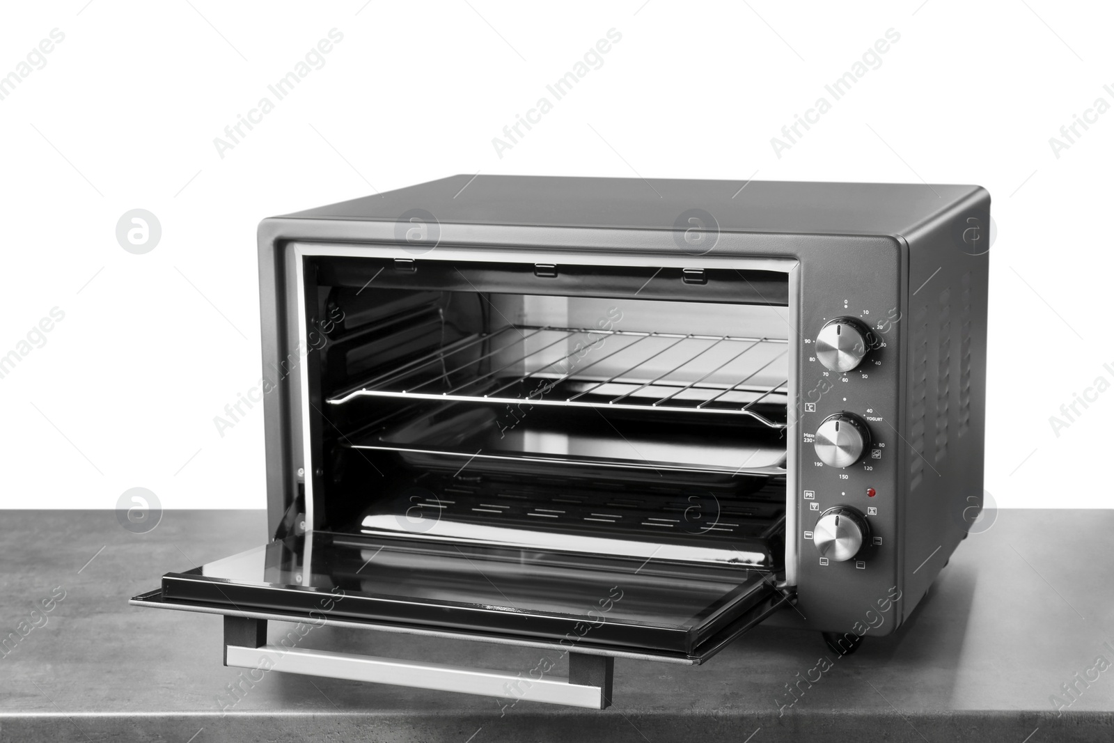 Photo of One electric oven on grey table against white background