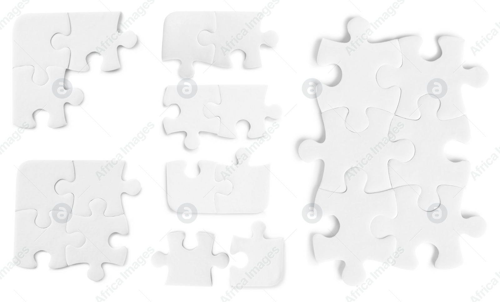 Image of Set with jigsaw puzzle pieces on white background, top view