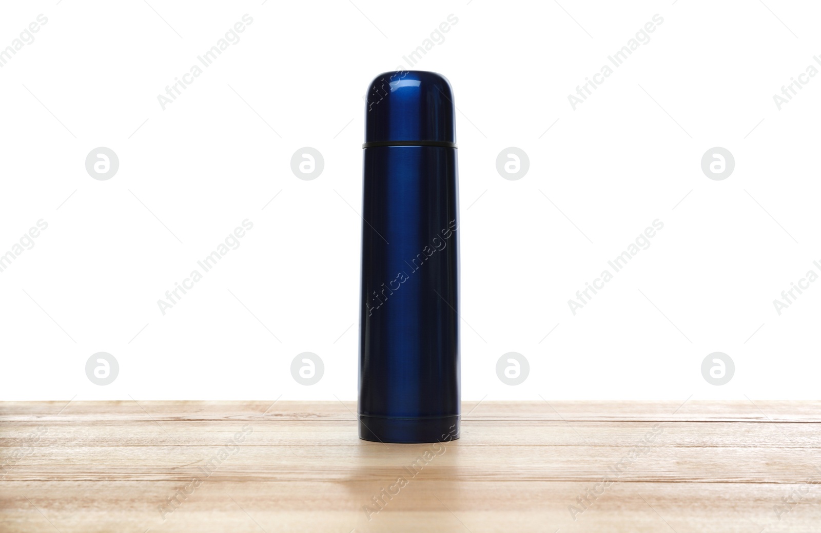 Photo of Stylish thermo bottle on wooden table against white background