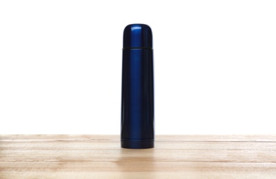 Stylish thermo bottle on wooden table against white background