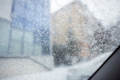 Photo of Car window covered with snow, view from inside