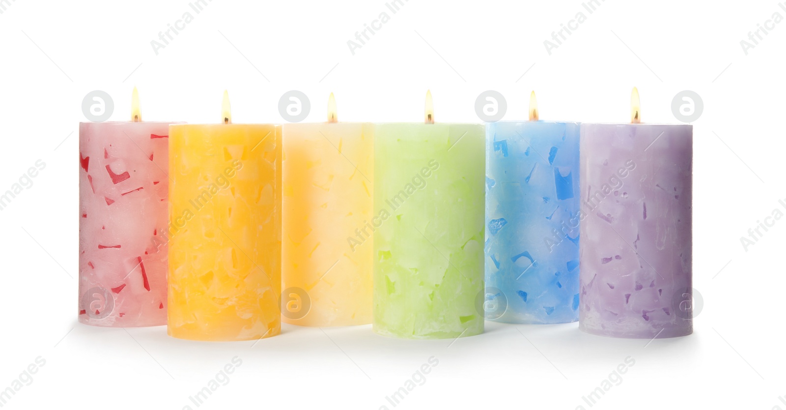 Photo of Alight color wax candles on white background