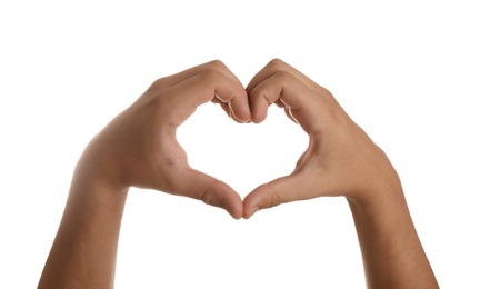 Teenage boy showing heart with hands on white background, closeup