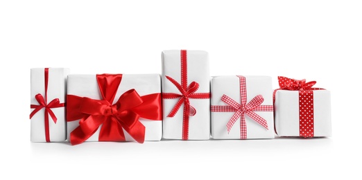 Photo of Beautifully wrapped gift boxes on white background