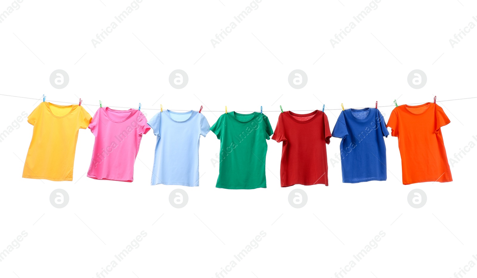 Photo of Colorful t-shirts drying on washing line isolated on white