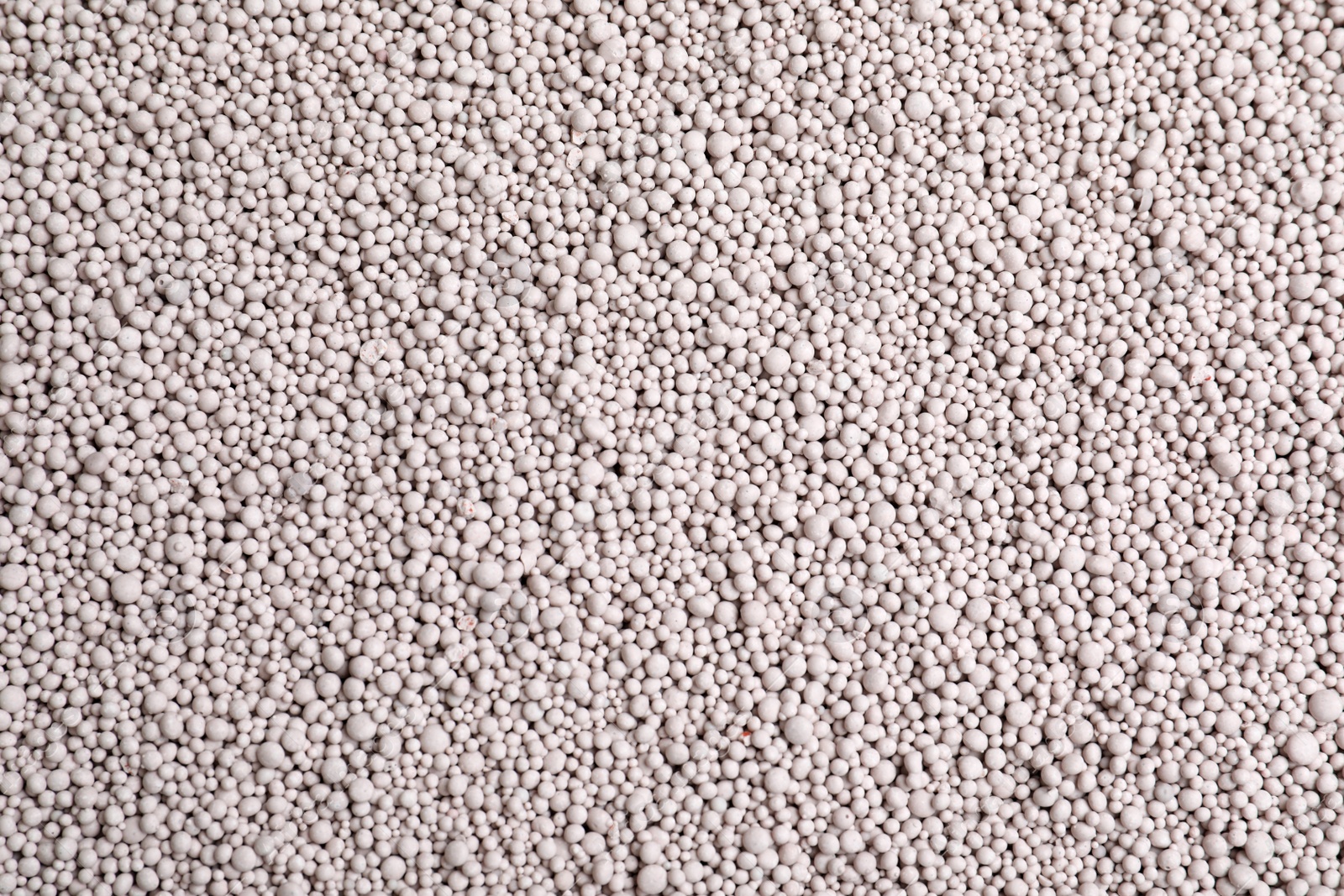 Photo of Textured chemical fertilizer for gardening as background, top view