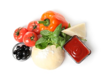 Photo of Composition with dough and fresh ingredients for pizza isolated on white, top view