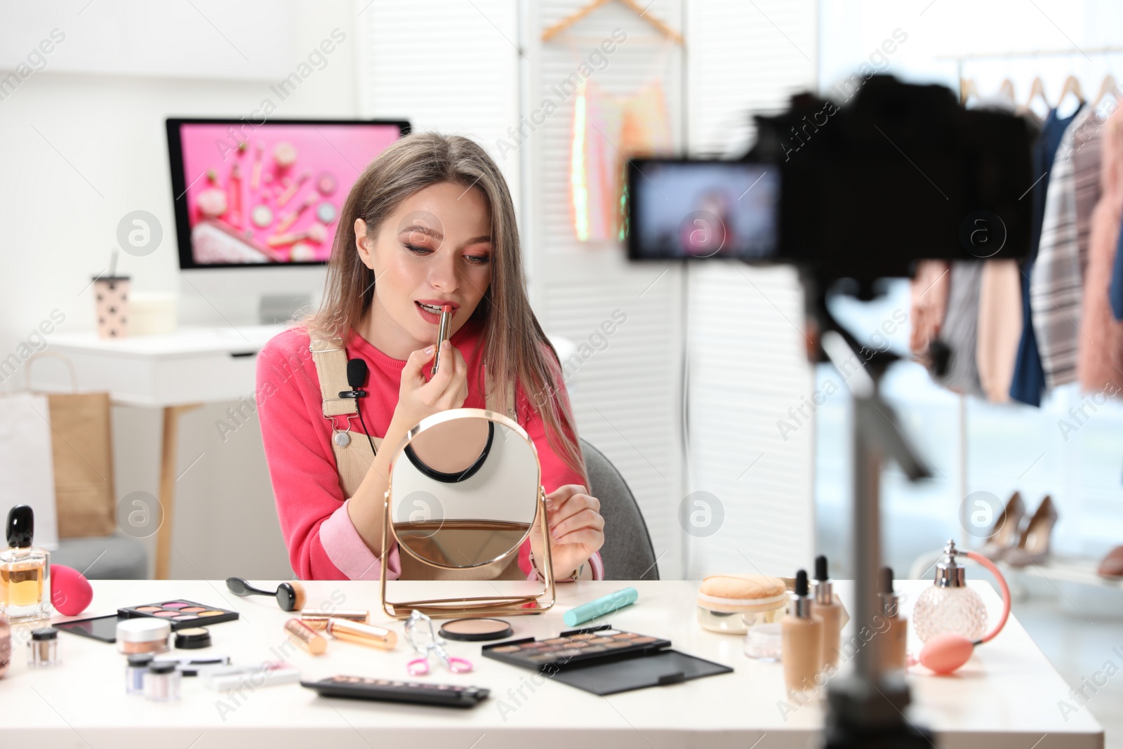 Photo of Beauty blogger filming make up tutorial at home