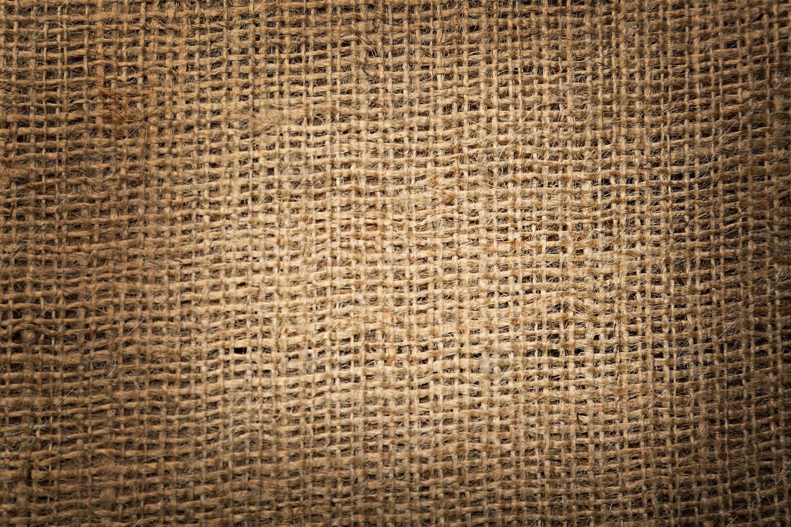 Image of Texture of natural burlap fabric as background, top view. Vignette effect 