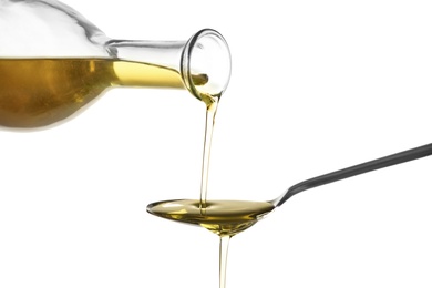 Photo of Pouring fresh olive oil into spoon on white background