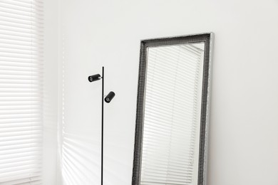 Stylish makeup room interior with long mirror and lamp