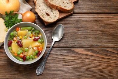 Bowl of delicious turnip soup served on wooden table, flat lay. Space for text