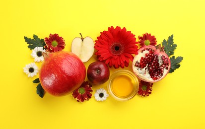 Flat lay composition with Rosh Hashanah holiday attributes on yellow background