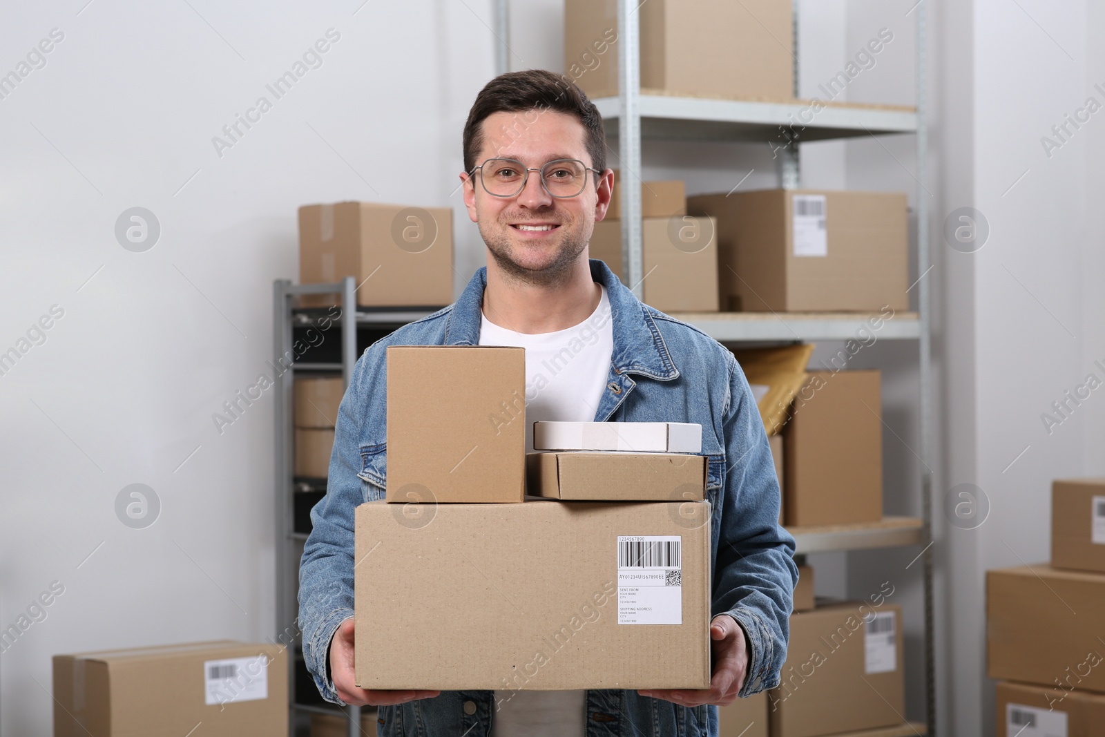 Photo of Seller with parcels in office. Online store