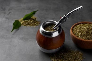 Photo of Calabash with mate tea and bombilla on light grey table