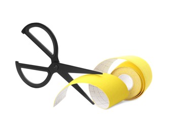 Photo of Yellow kinesio tape in roll and scissors on white background
