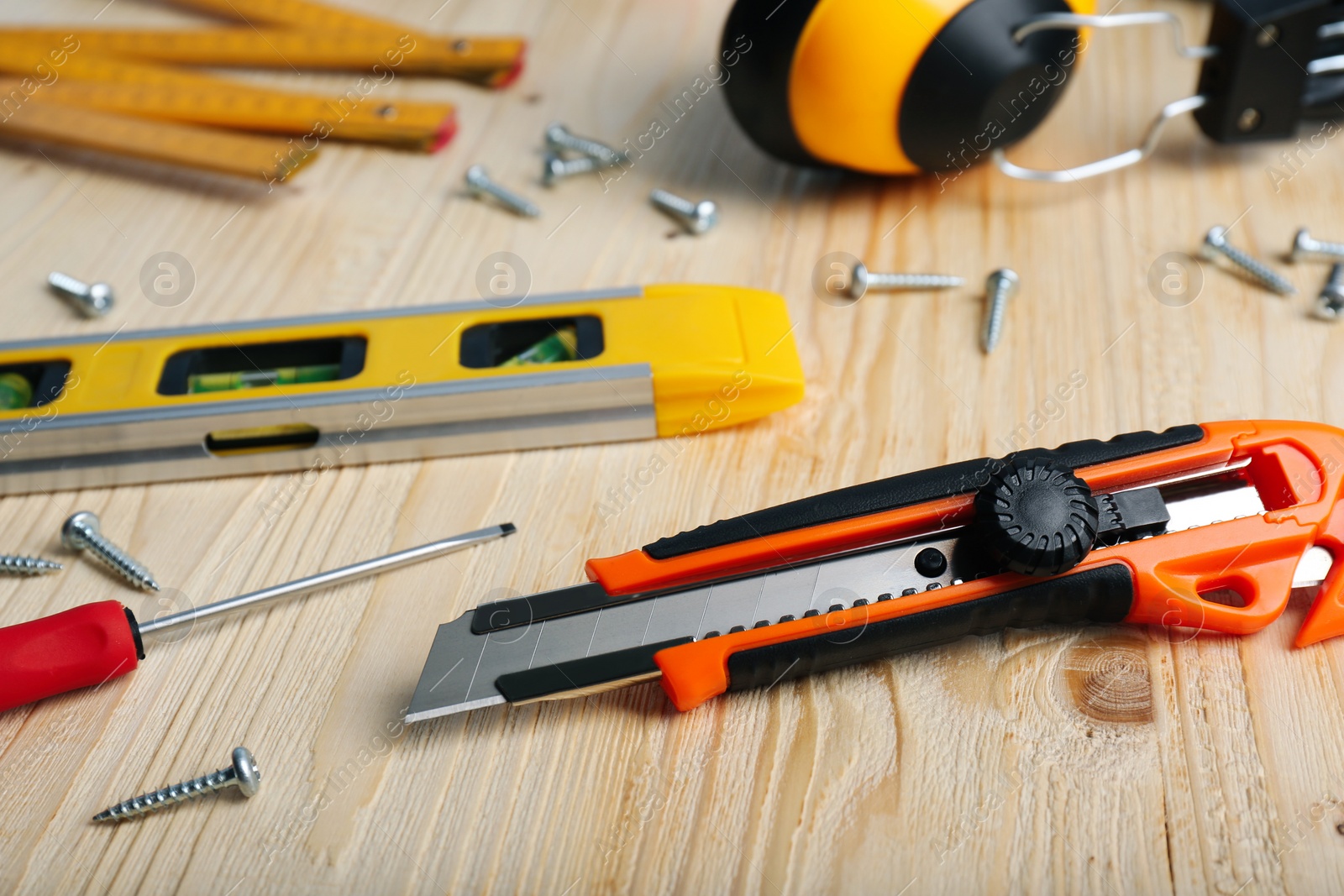 Photo of Utility knife and different tools on wooden table