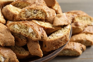 Photo of Traditional Italian almond biscuits (Cantucci) in bowl on table, closeup