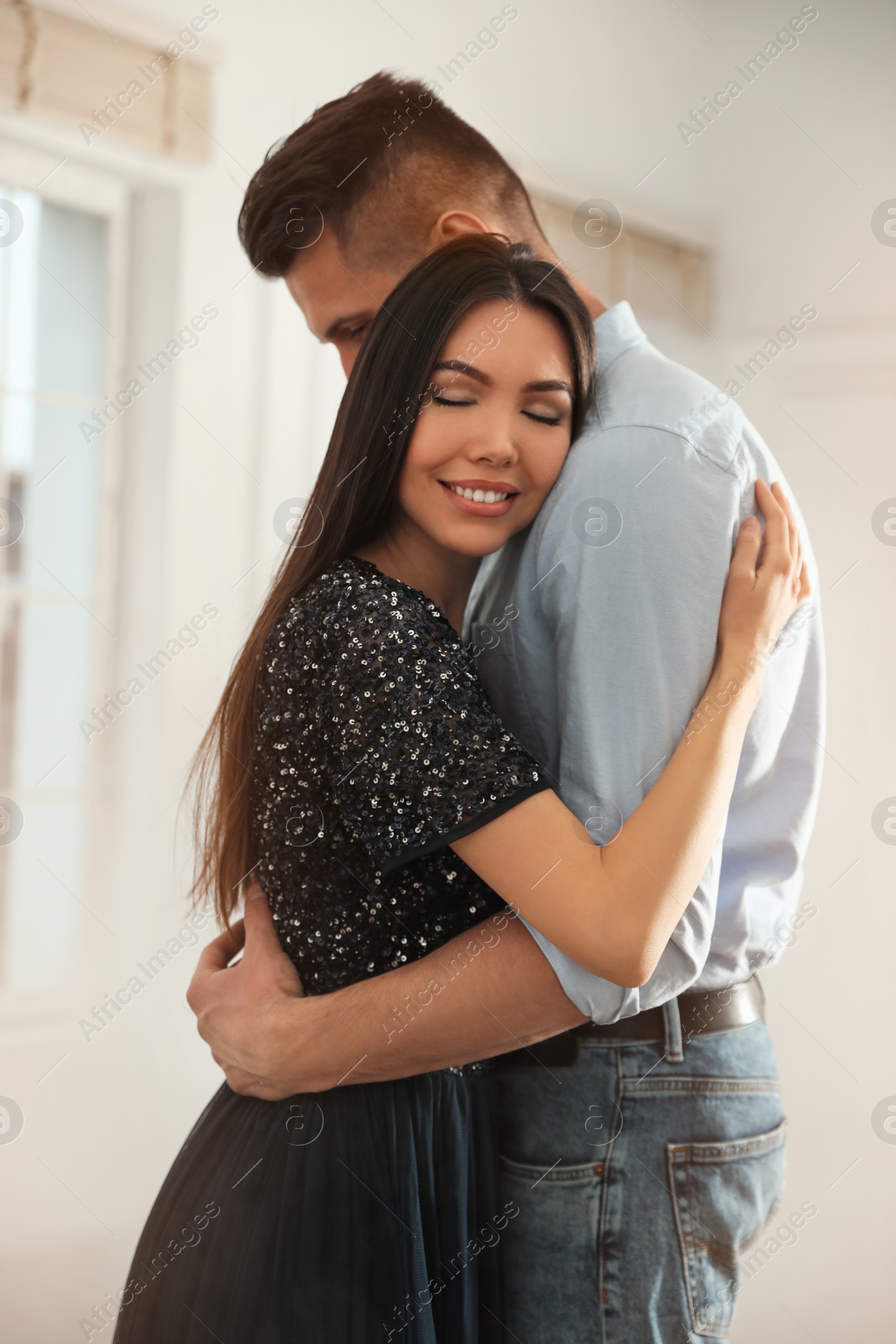 Photo of Lovely young couple dancing together in ballroom