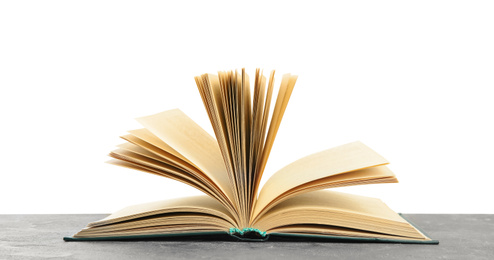 Open book on grey stone table against white background