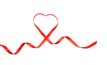 Photo of Heart made of red ribbon on white background, top view