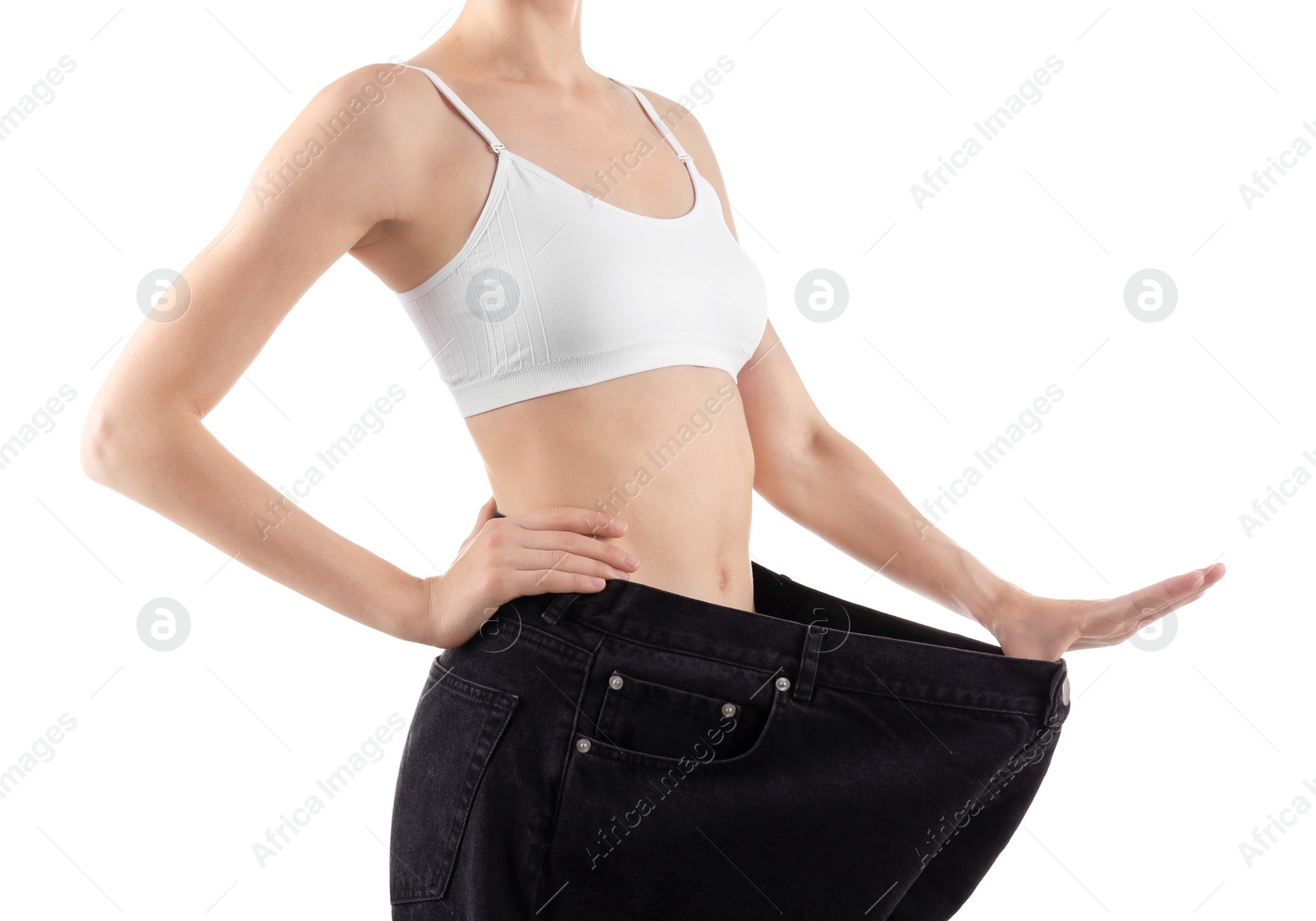 Photo of Young slim woman wearing oversized jeans on white background, closeup