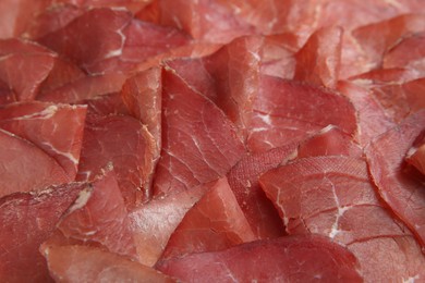 Slices of tasty bresaola as background, closeup