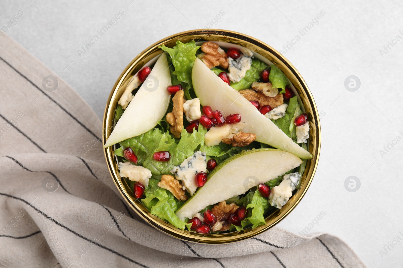 Photo of Delicious pear salad in bowl on light table, top view