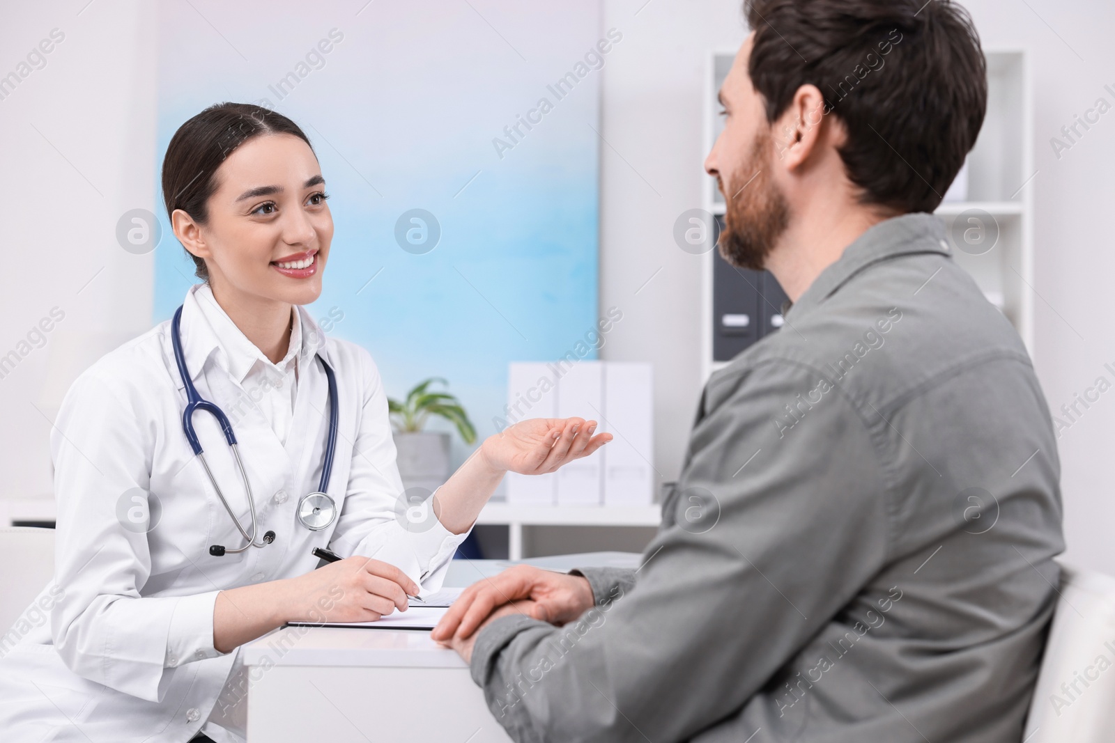 Photo of Doctor consulting patient during appointment in clinic